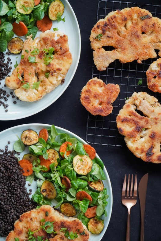 Breaded and roasted cauliflower with a zucchini and carrot spinach salad.